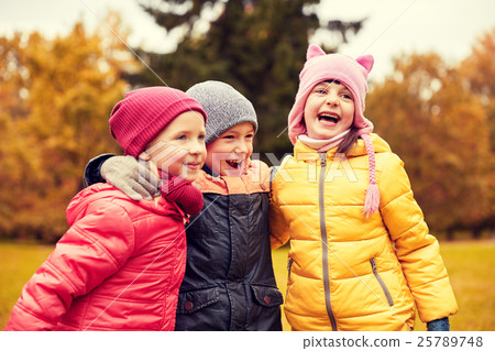 group of happy children hugging in autumn park 25789748