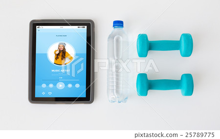 close up of tablet pc, dumbbells and water bottle close up of tablet pc, dumbbells and water bottle 25789775