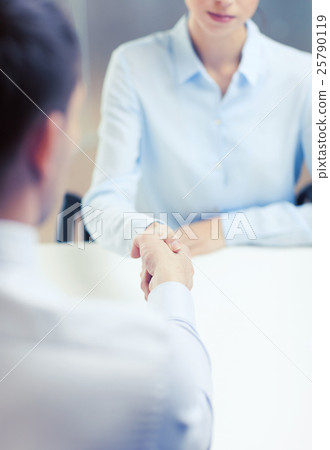 businesswoman and businessman shaking hands 25790119