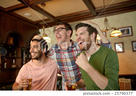 friends with beer watching sport at bar or pub 25790377