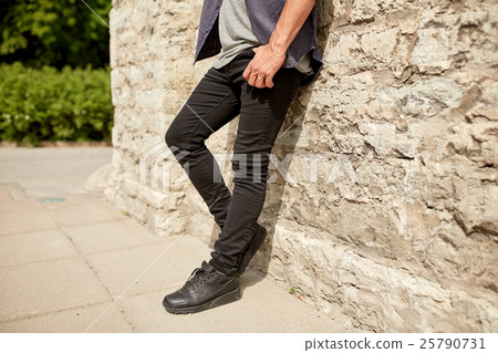 close up of man standing at street wall 25790731