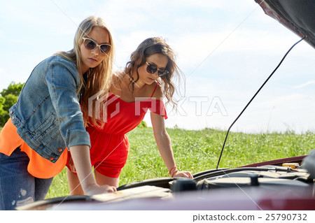 women with open hood of broken car at countryside 25790732
