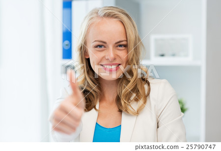happy businesswoman showing thumbs up at office 25790747