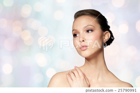 close up of beautiful woman face with earring close up of beautiful woman face with earring 25790991