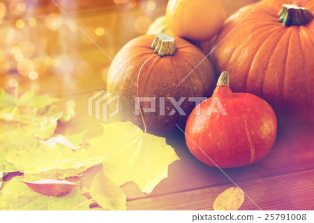 close up of pumpkins on wooden table at home close up of pumpkins on wooden table at home 25791008