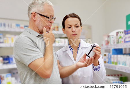 pharmacist showing drug to senior man at pharmacy pharmacist showing drug to senior man at pharmacy 25791035