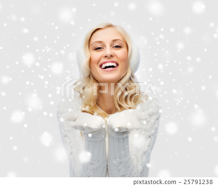 woman in winter earmuffs showing empty palms 25791238