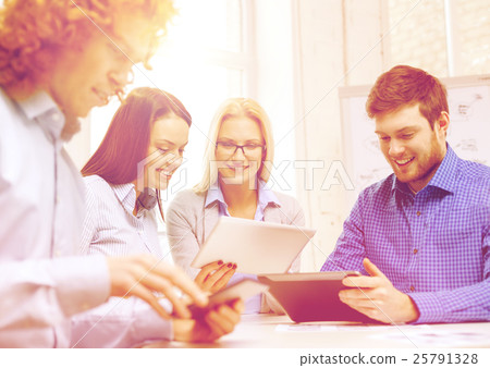 smiling team with table pc and papers working smiling team with table pc and papers working 25791328