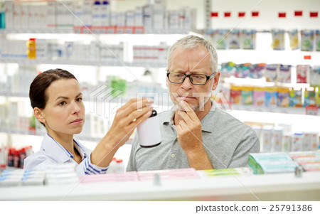 pharmacist showing drug to senior man at pharmacy 25791386