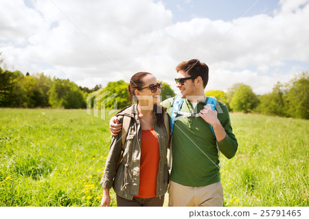 happy couple with backpacks hiking outdoors happy couple with backpacks hiking outdoors 25791465