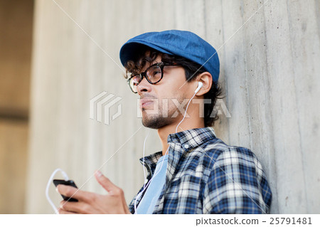 man with earphones and smartphone listening music 25791481