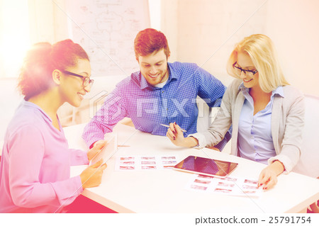 smiling team with table pc and papers working smiling team with table pc and papers working 25791754