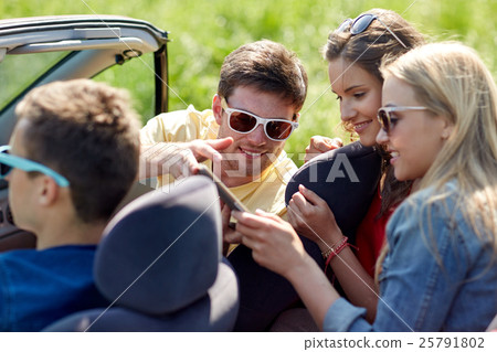 friends with tablet pc driving in cabriolet car 25791802