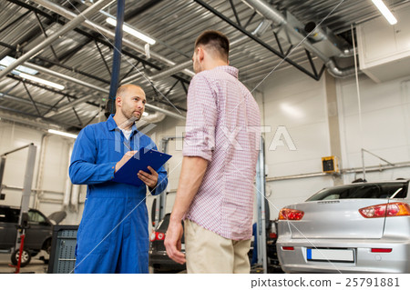auto mechanic with clipboard and man at car shop 25791881