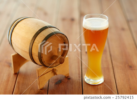 close up of beer glass and wooden barrel on table 25792415
