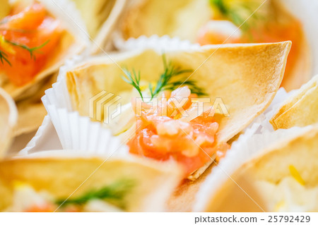 close up of dough cornet with salmon fish filling close up of dough cornet with salmon fish filling 25792429