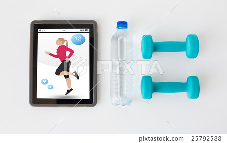 close up of tablet pc, dumbbells and water bottle close up of tablet pc, dumbbells and water bottle 25792588