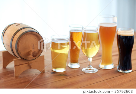 close up of different beers in glasses on table 25792608