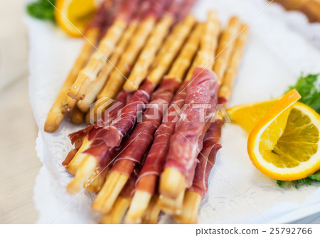 close up of grissini bread sticks with prosciutto close up of grissini bread sticks with prosciutto 25792766