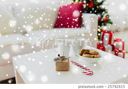 close up of gift, sweets and cups on table at home 25792815