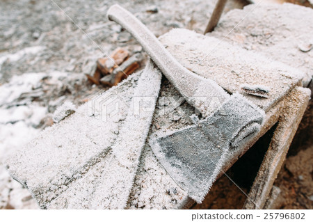 Close-up of frosted axe on wooden table Close-up of frosted axe on wooden table 25796802