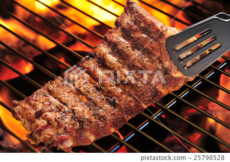 Grilled pork ribs on the flaming grill 25798528
