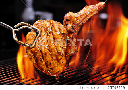 Grilled pork chops on the flaming grill 25798529