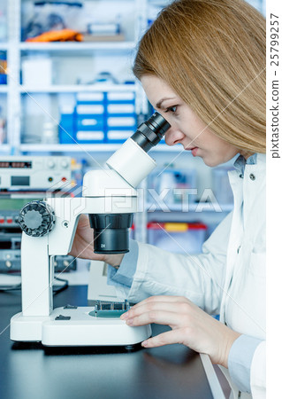 Development of electronic device. Young female technician in la Development of electronic device. Young female technician in la 25799257