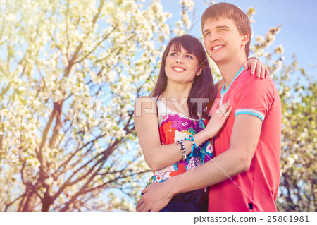 Young couple enjoying in blooming garden 25801981