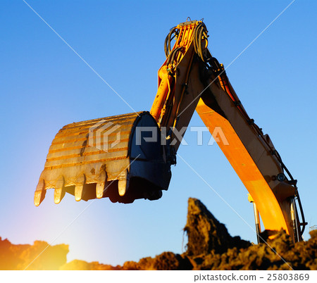 Shovel bucket against blue sky Shovel bucket against blue sky 25803869