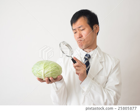 A man with cabbage with a troubled look 25805877