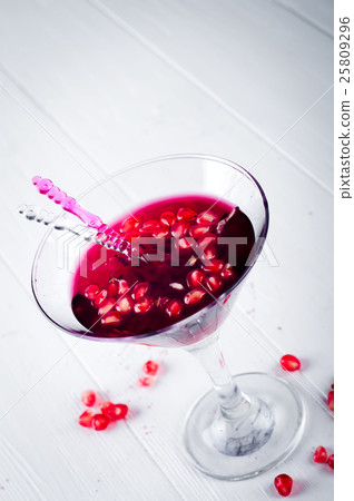 Pomegranate martini with seeds in a glass Pomegranate martini with seeds in a glass 25809296