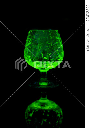 Glass of whiskey glow in the dark. Glass of whiskey glow in the dark. 25812803
