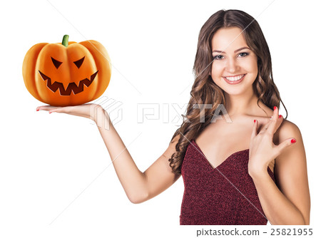 Young woman holding carved pumpkin. Young woman holding carved pumpkin. 25821955