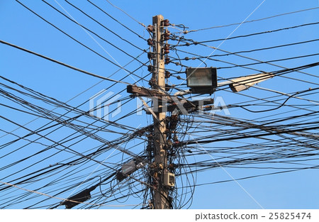A street lamp post with many electrical cables A street lamp post with many electrical cables 25825474