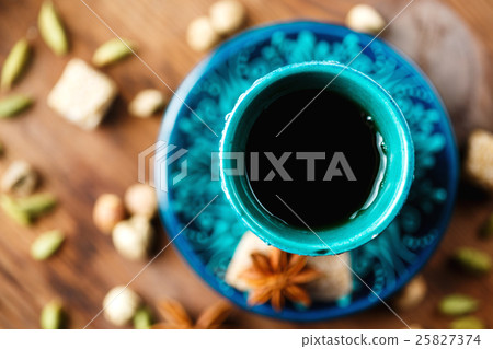 Hot drink with spices in authentic cup 25827374