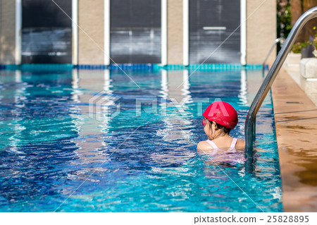 Child Resting at Edge of Swimming Pool After Swimming Training 25828895