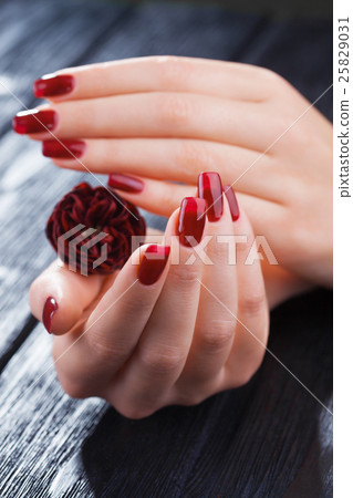 red manicure with rose flower. spa 25829031