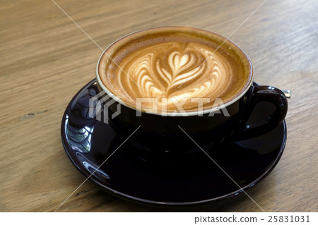 Hot coffee latte on a wooden table. Hot coffee latte on a wooden table. 25831031