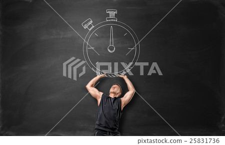 Muscular sportsman holding up big timer, drawn on the blackboard. Muscular sportsman holding up big timer, drawn on the blackboard. 25831736