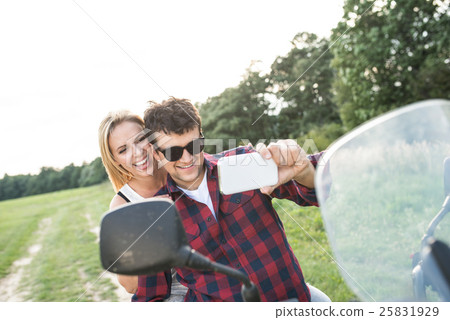 Couple in love enjoying a quad bike ride in Couple in love enjoying a quad bike ride in 25831929