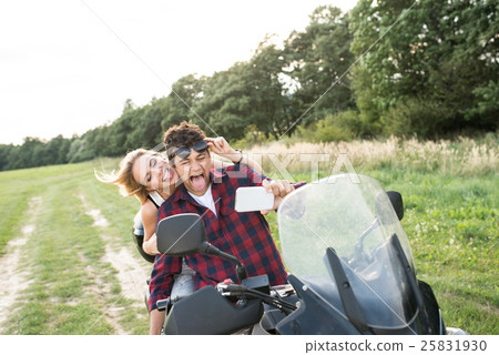 Couple in love enjoying a quad bike ride in 25831930