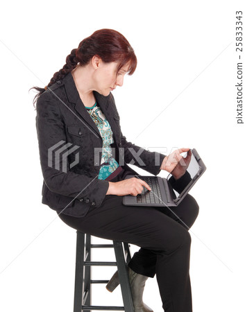 Woman working on her laptop. Woman working on her laptop. 25833343