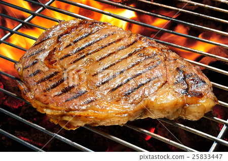 Grilled beef steak on the flaming grill, rib-eye 25833447