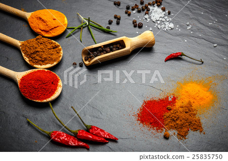 Stock Photo: spices and herbs over black stone background