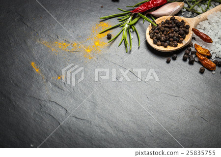 Stock Photo: spices and herbs over black stone background