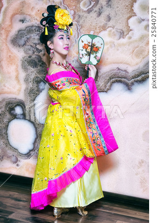 chinese woman wearing traditional yellow dress chinese woman wearing traditional yellow dress 25840771