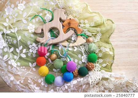 Two wooden toys with knitted beads. 25840777