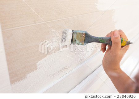 hand worker holding brush painting white on wood 25846926