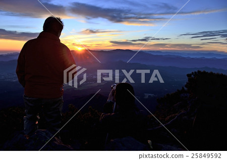 A mountaineer waiting for a sunrise at the Akaki summit peak A mountaineer waiting for a sunrise at the Akaki summit peak 25849592